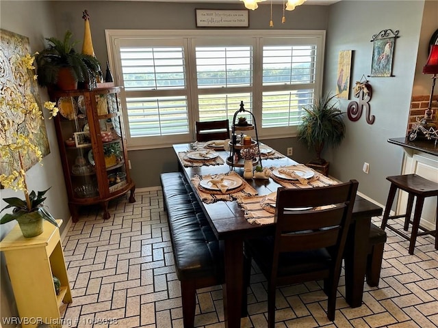 7434 N 217th Hwy, Charleston, AR 72933 - dining area featuring brick floors and baseboards