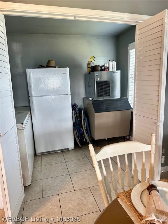 7434 N 217th Hwy, Charleston, AR 72933 - kitchen with freestanding refrigerator, light tile patterned floors, and washer / clothes dryer