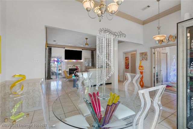 6501 Galven Way, Fort Smith, AR 72916 - dining area with a fireplace, light tile patterned floors, a chandelier, a ceiling fan, and a high ceiling