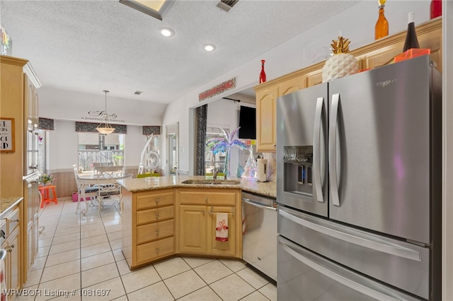 6501 Galven Way, Fort Smith, AR 72916 - kitchen with stainless steel appliances, a peninsula, light tile patterned floors, a textured ceiling, and decorative light fixtures