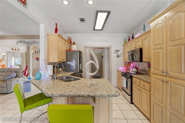 6501 Galven Way, Fort Smith, AR 72916 - kitchen with stainless steel appliances, a breakfast bar area, light brown cabinetry, a peninsula, and light tile patterned floors