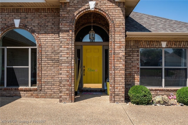 6501 Galven Way, Fort Smith, AR 72916 - doorway to property with roof with shingles and brick siding