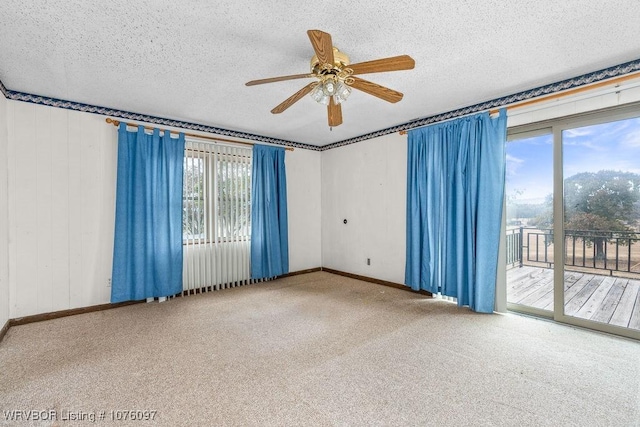 spare room featuring a textured ceiling, carpet floors, and ceiling fan