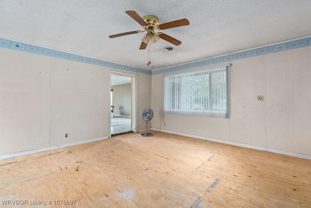 spare room featuring ceiling fan and a textured ceiling