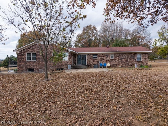 rear view of house featuring cooling unit