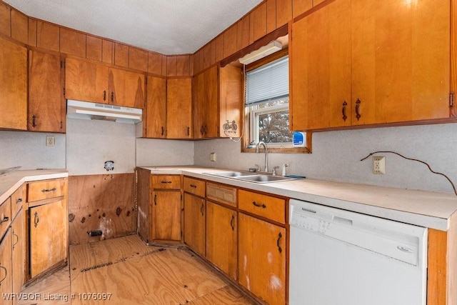 kitchen featuring a textured ceiling, white dishwasher, and sink