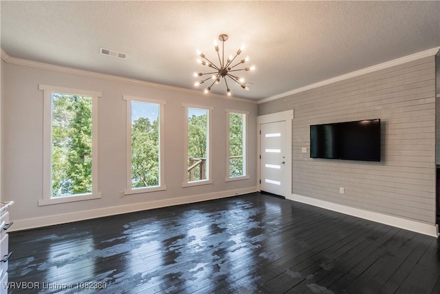 8721 Northshore Dr, Hackett, AR 72937 - unfurnished living room featuring plenty of natural light, a chandelier, dark wood-style flooring, and ornamental molding