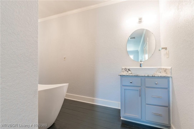8721 Northshore Dr, Hackett, AR 72937 - bathroom with ornamental molding, vanity, a freestanding bath, hardwood / wood-style floors, and a textured wall