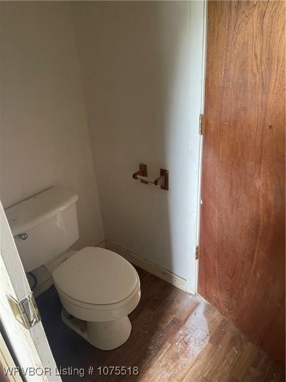 bathroom featuring hardwood / wood-style floors and toilet