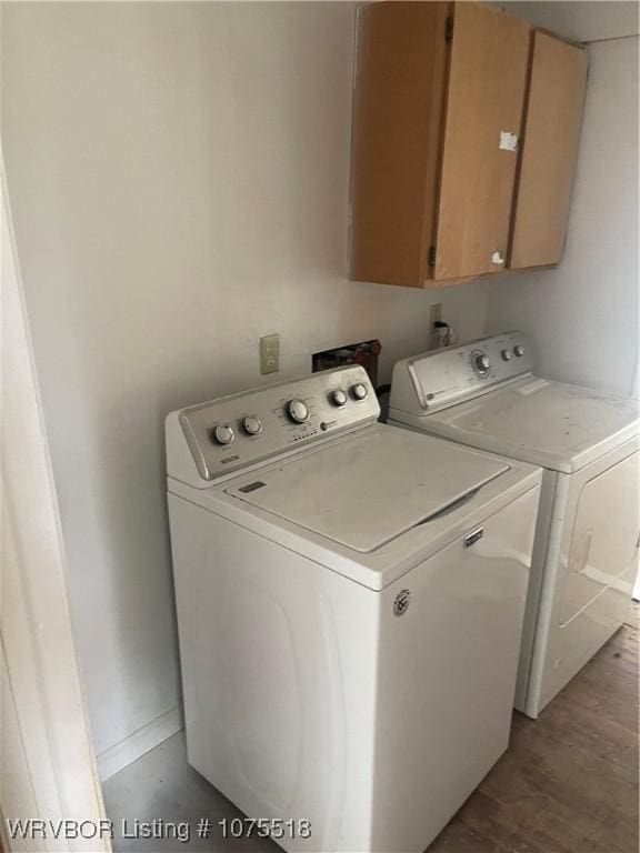 laundry room featuring cabinets and washer and clothes dryer