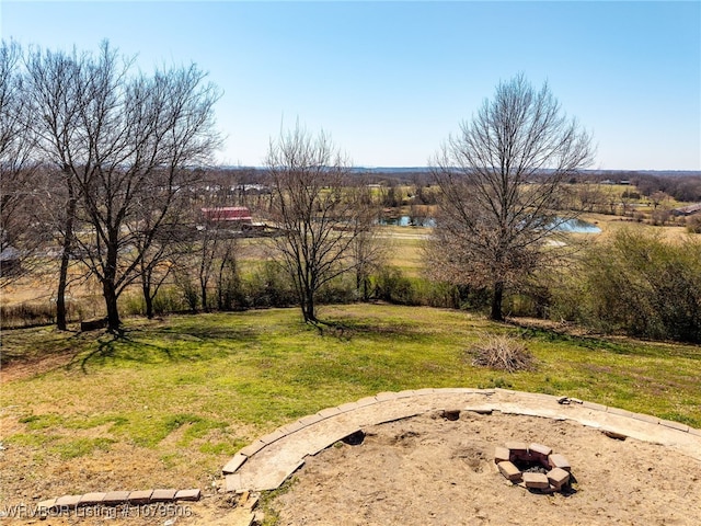 view of yard with a fire pit