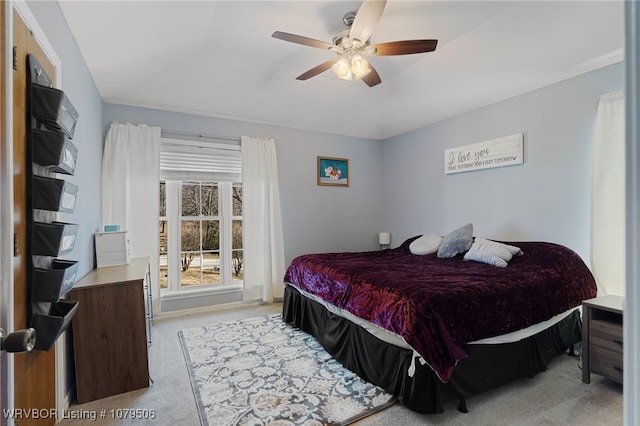 bedroom featuring light colored carpet and ceiling fan