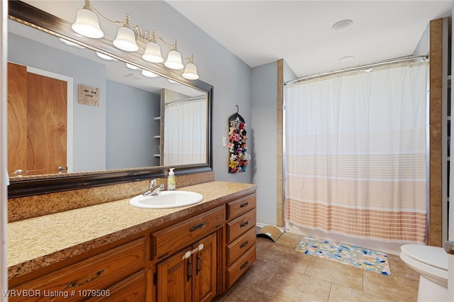 bathroom featuring tile patterned flooring, toilet, vanity, and shower / bathtub combination with curtain