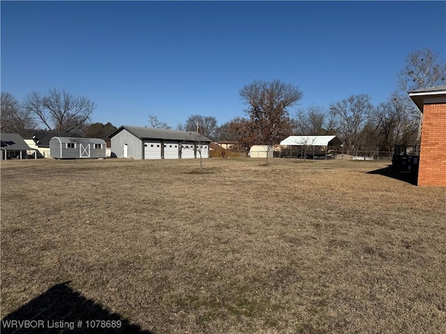 view of yard with a garage and a storage unit