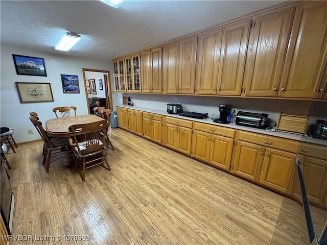 kitchen with light hardwood / wood-style flooring and a textured ceiling