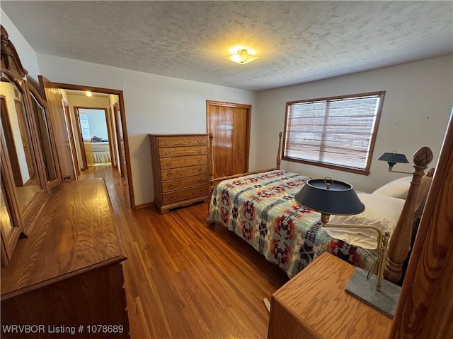 bedroom with hardwood / wood-style flooring and a textured ceiling