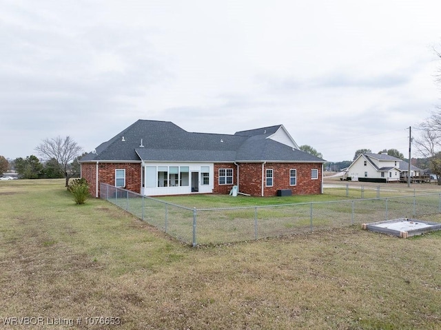 rear view of house featuring a lawn