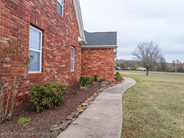 view of side of home featuring a lawn