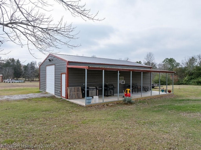 view of outbuilding with a lawn and a garage