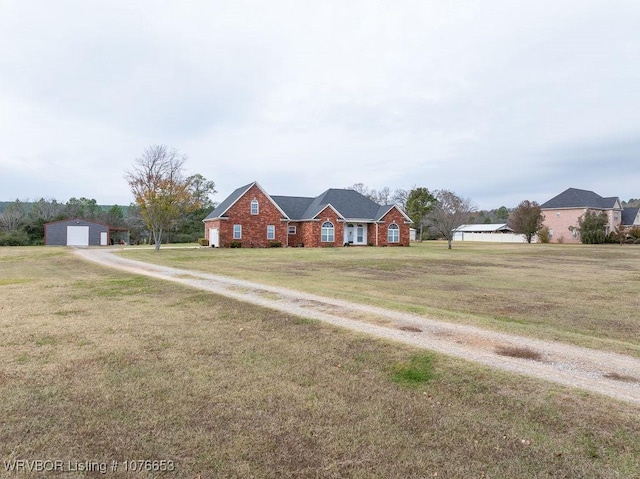 ranch-style house with a garage, an outbuilding, and a front lawn