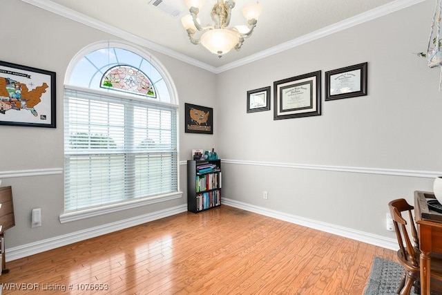 interior space with light hardwood / wood-style flooring, a wealth of natural light, ornamental molding, and a notable chandelier