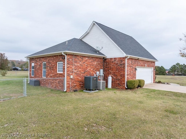 view of home's exterior with a lawn, central AC unit, and a garage