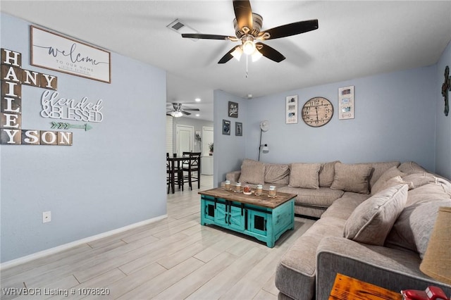 living room with ceiling fan and light wood-type flooring