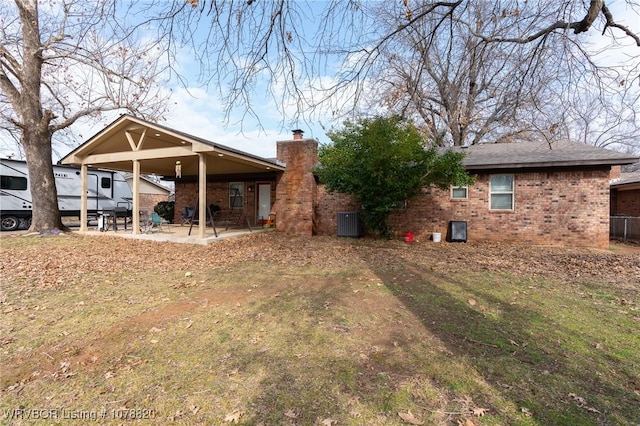 back of house with central AC unit and a patio area