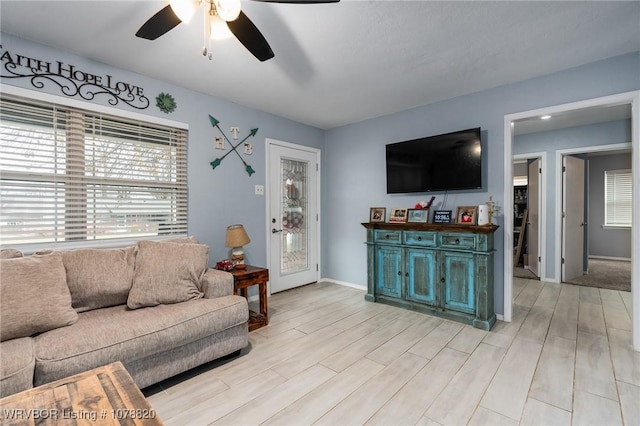 living room featuring ceiling fan and light hardwood / wood-style flooring