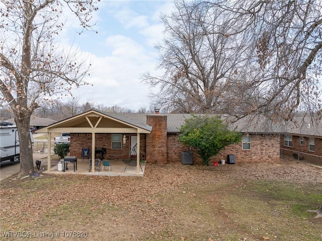 rear view of house with a patio and central air condition unit