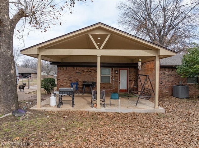 back of property with central air condition unit and a patio area