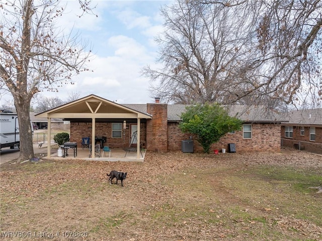 back of property featuring central AC and a patio area