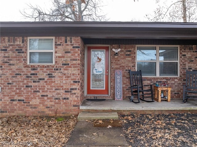 view of exterior entry with covered porch