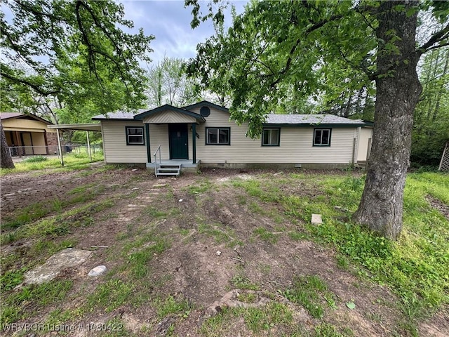 view of front of house featuring crawl space and a carport