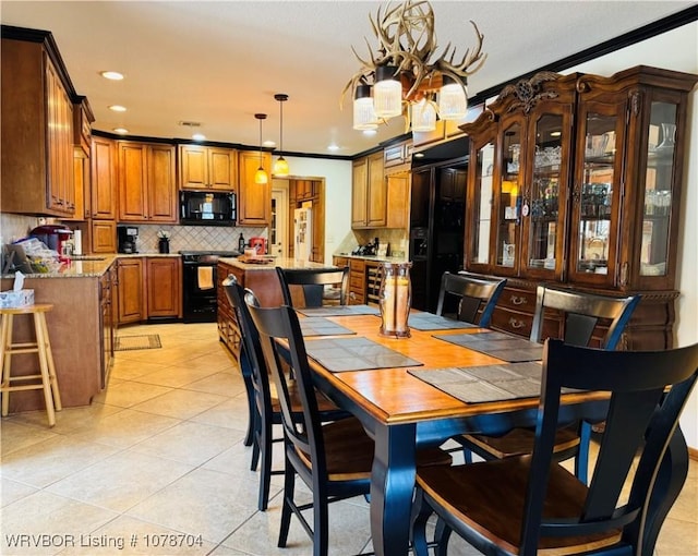 tiled dining space featuring crown molding