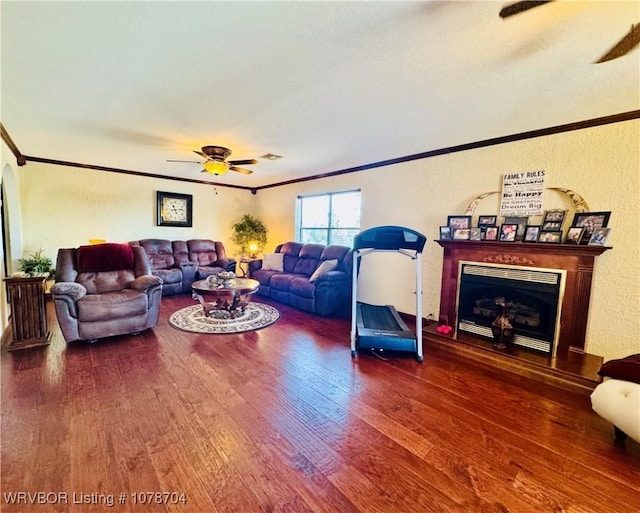 living room featuring hardwood / wood-style floors, crown molding, and ceiling fan