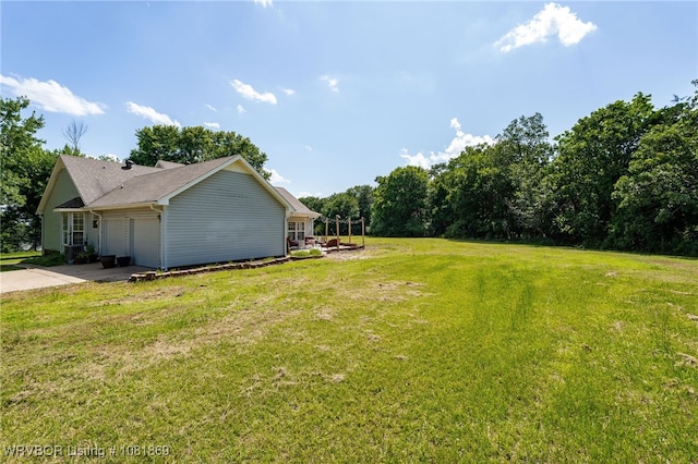 3109 Twin Lakes Pl, Alma, AR 72921 - view of green lawn featuring a garage and concrete driveway