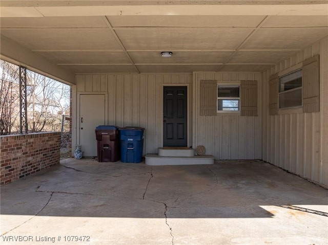 entrance to property featuring a carport and board and batten siding