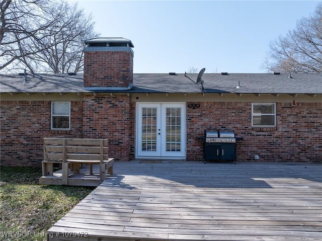 wooden terrace with grilling area and french doors