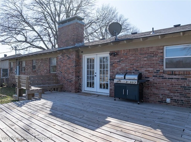 wooden deck featuring area for grilling and french doors