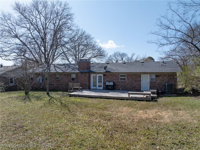 back of property featuring a deck, a yard, french doors, and central AC