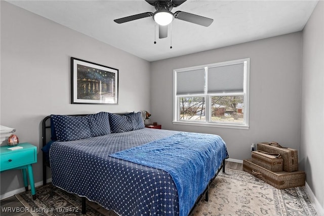 bedroom with wood finished floors, baseboards, and ceiling fan