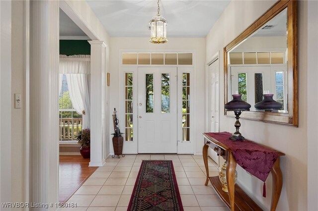 entrance foyer with baseboards and light tile patterned floors
