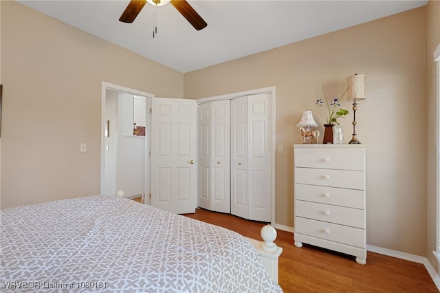 bedroom with ceiling fan, baseboards, wood finished floors, and a closet