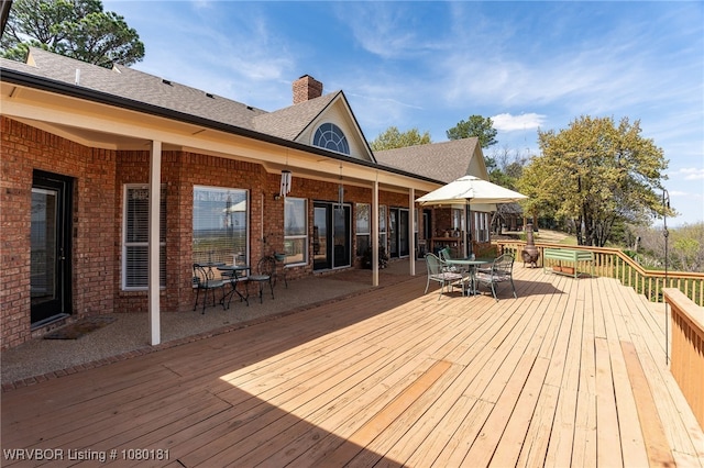 deck featuring outdoor dining area