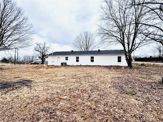 rear view of house featuring central AC