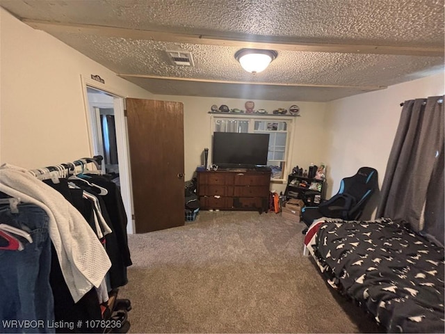 carpeted bedroom featuring a textured ceiling