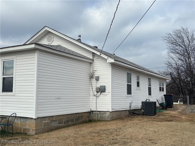 view of side of property with central AC unit