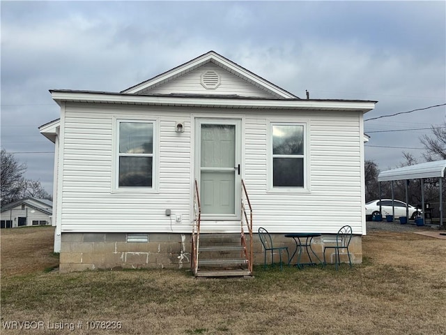 rear view of property with a lawn