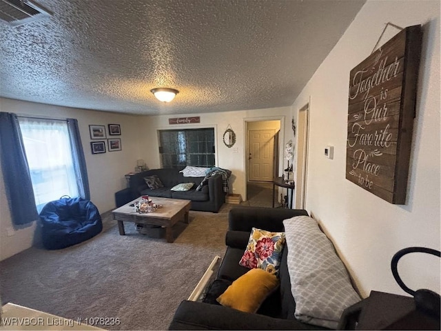 living room featuring carpet and a textured ceiling